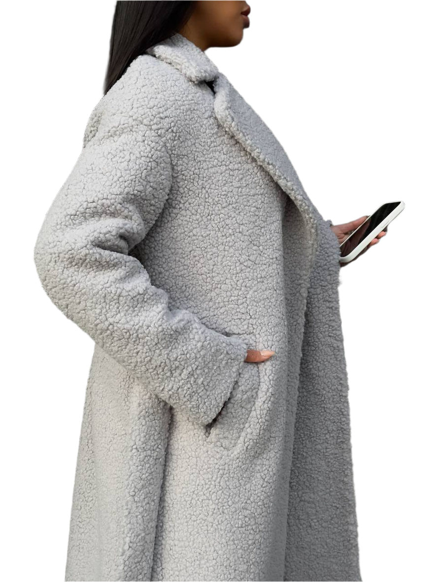 Person wearing a long gray teddy coat on a white background