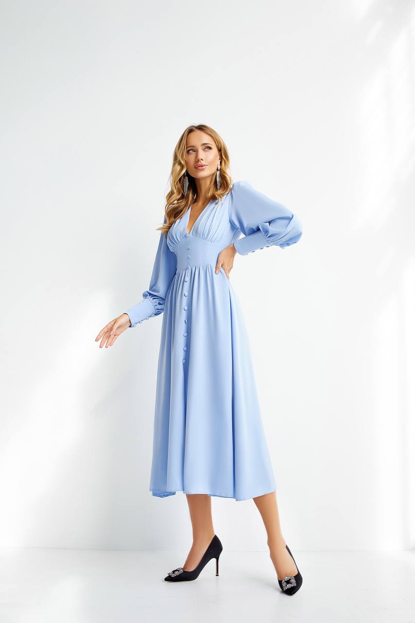 Woman wearing a light blue dress on a white background