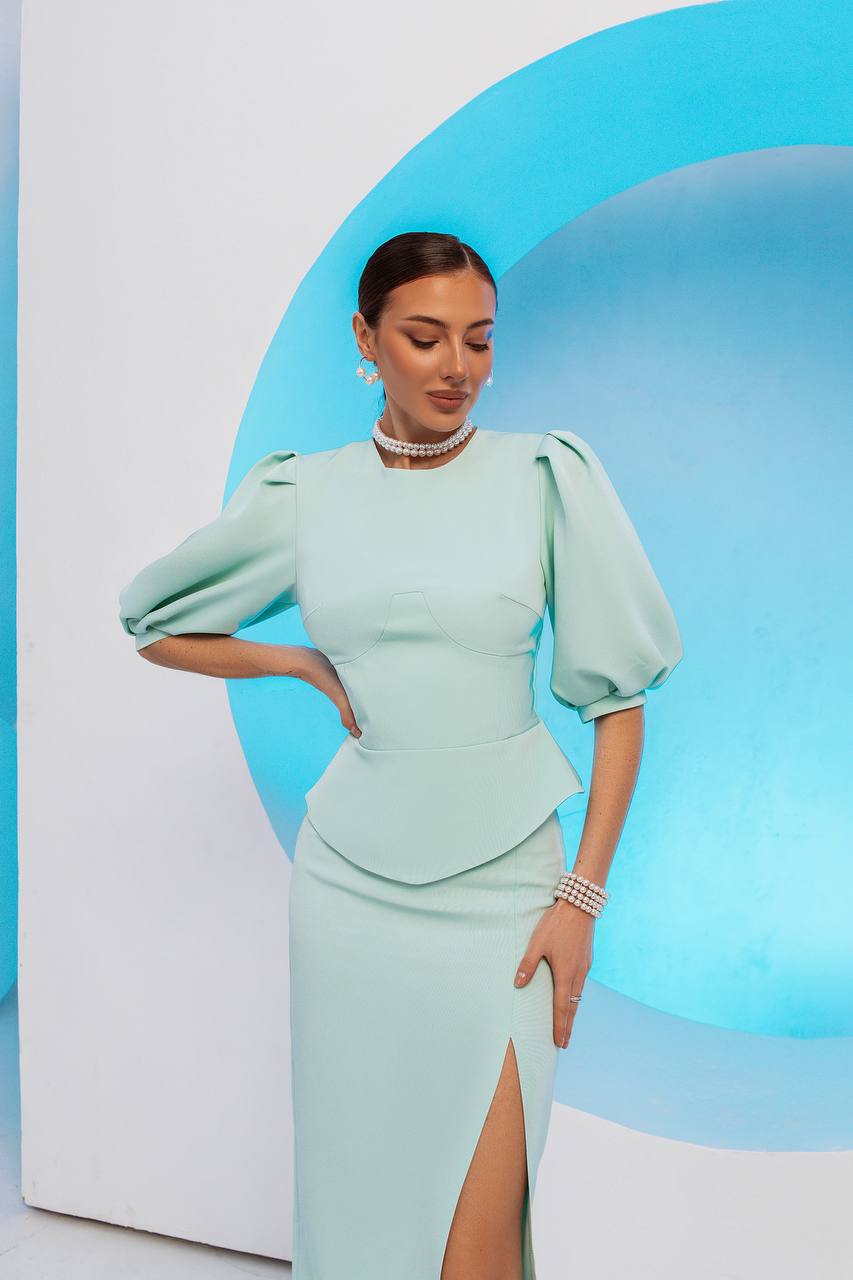 Woman wearing a light blue dress with a blue background