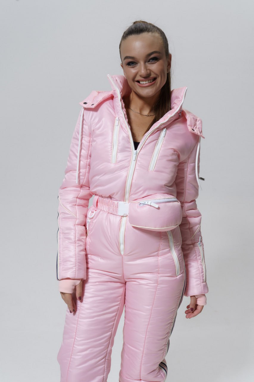 Person wearing a pink puffer suit on a plain background