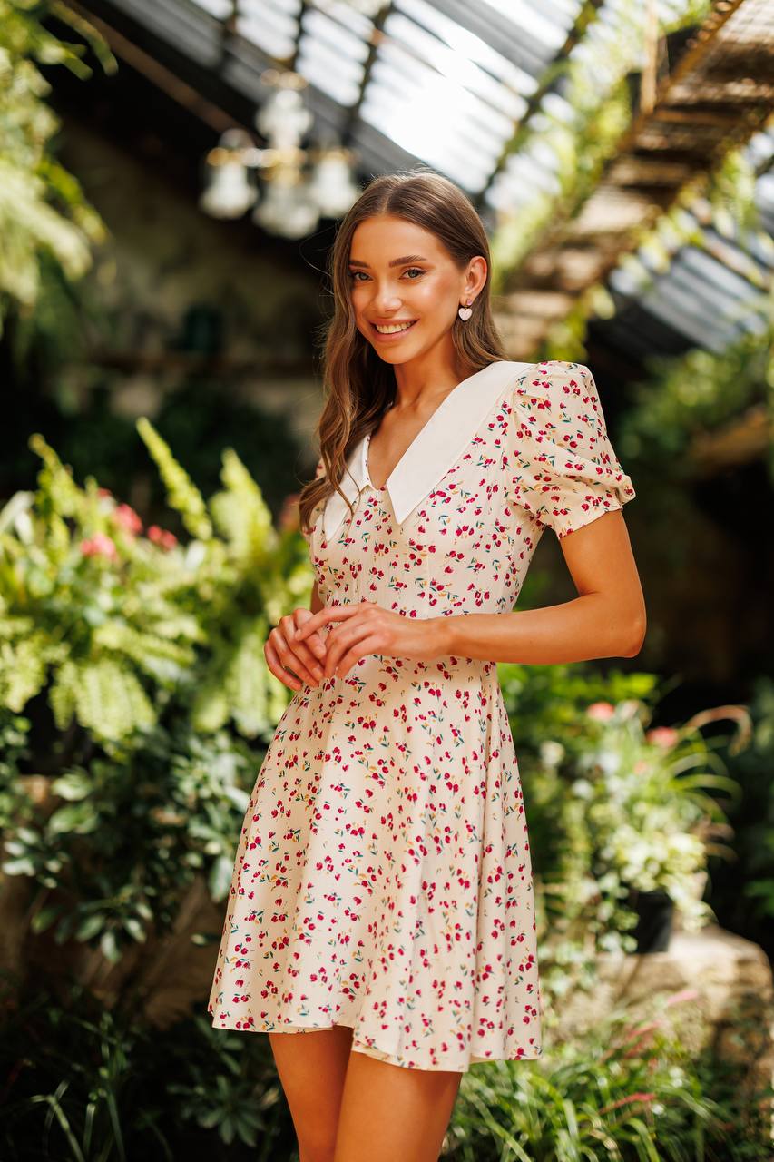 Woman in a floral dress standing in a garden