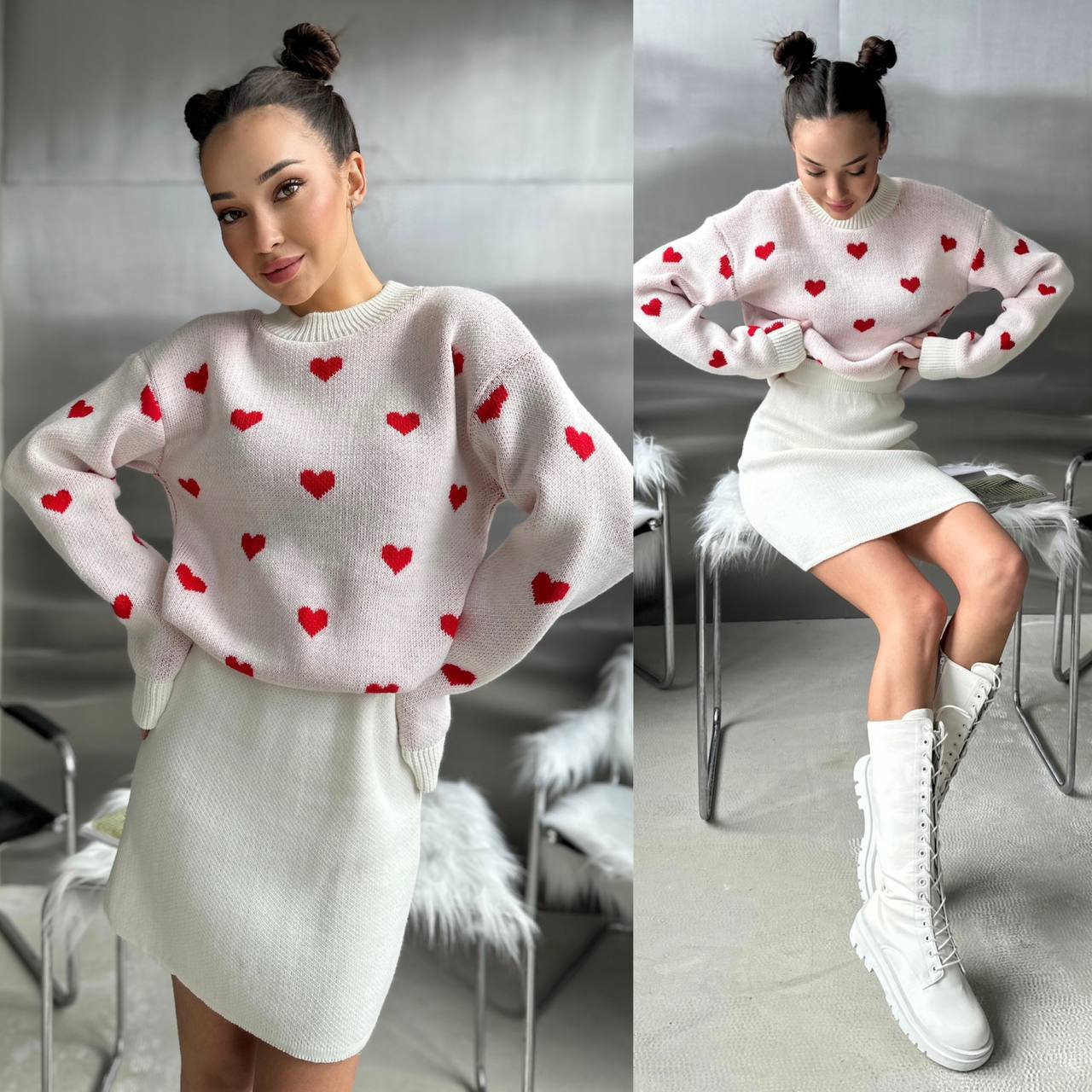 Woman wearing a white sweater with red heart patterns and a white skirt, sitting on a chair.
