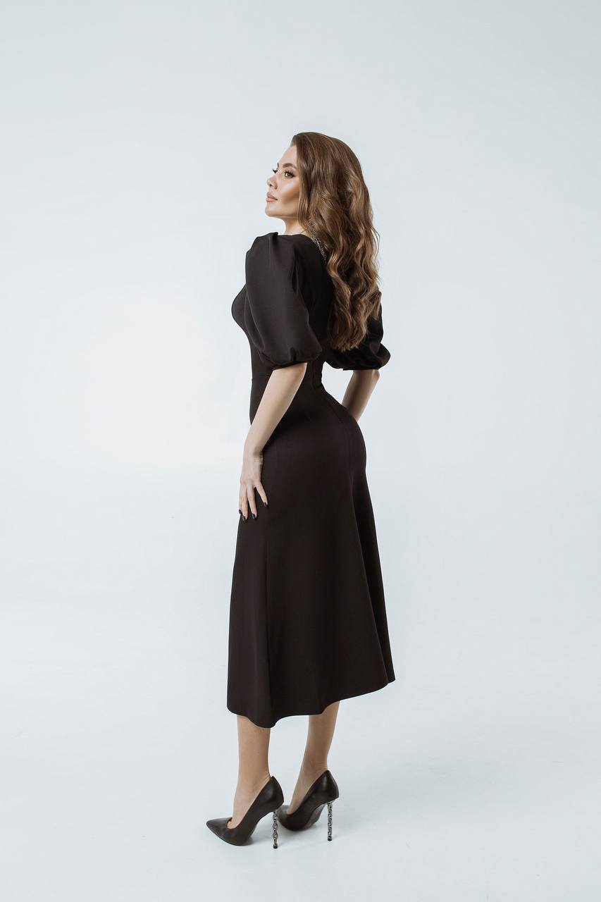 Woman wearing a black dress on a white background