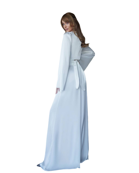 Person wearing a light blue dress with a cape on a white background