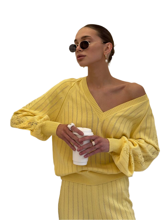 Woman wearing a yellow outfit holding a coffee cup on a white background