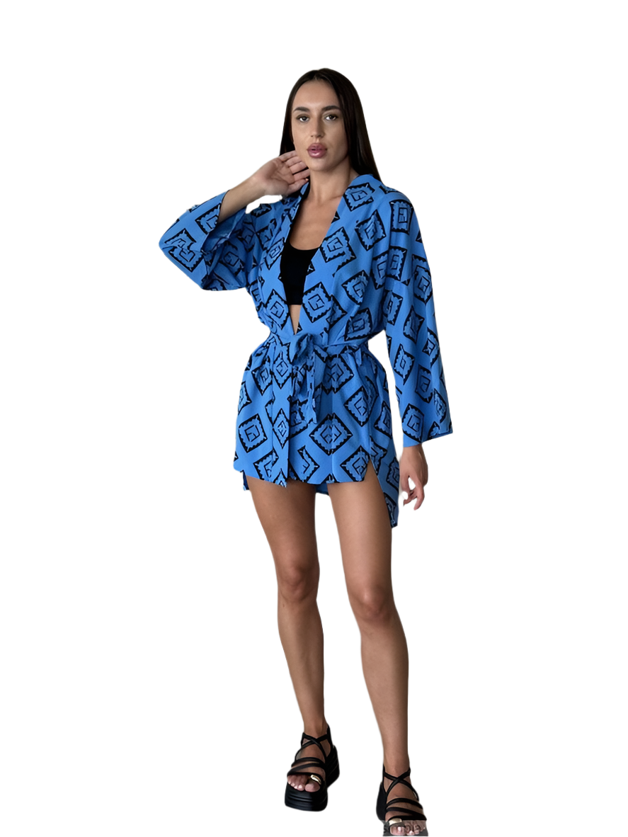 Woman wearing a blue patterned kimono-style garment on a white background