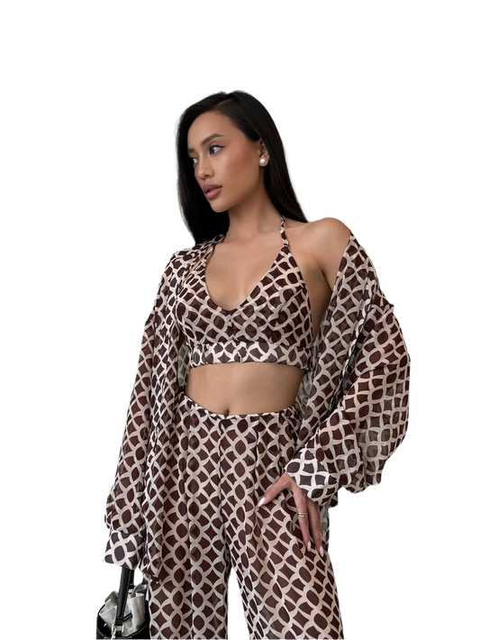 Woman wearing a patterned outfit on a white background