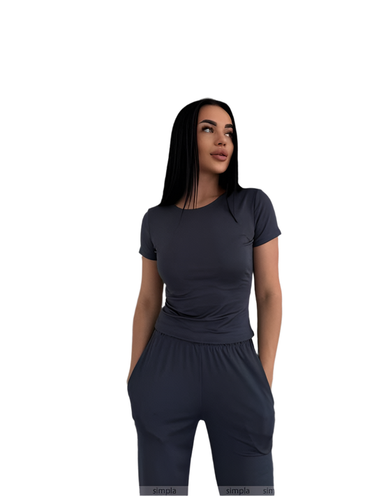 Woman wearing a dark gray outfit on a white background