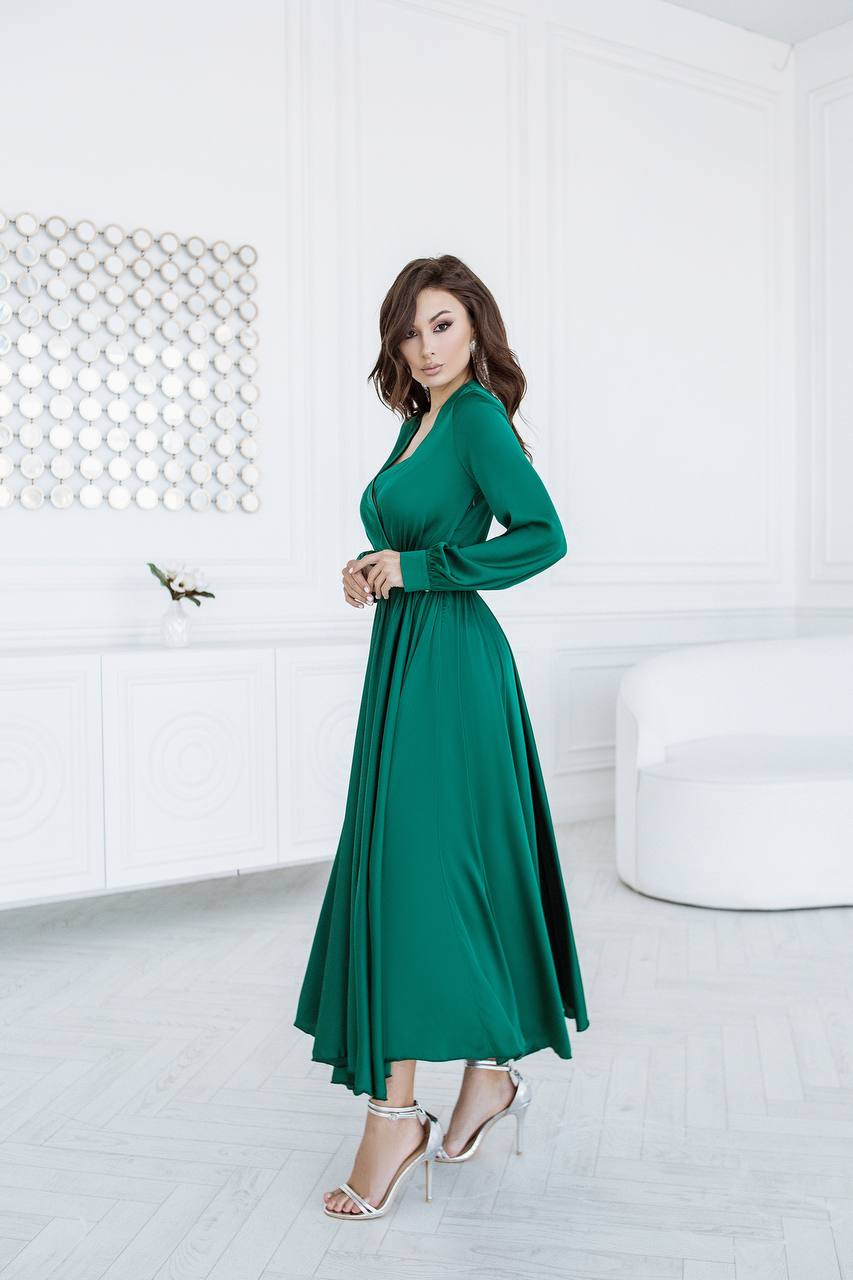 Woman wearing a green dress in a modern white room