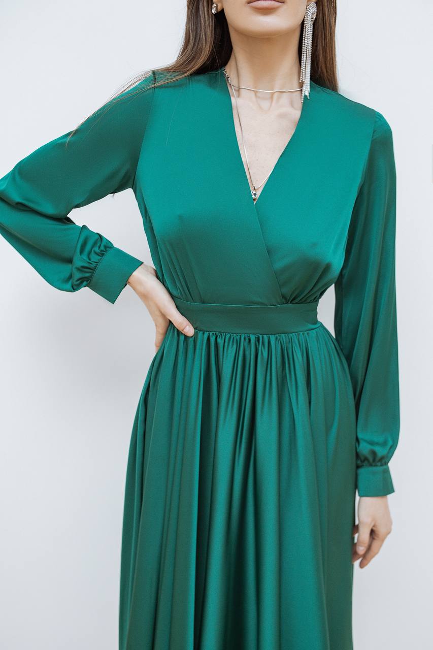 Green dress worn by a model against a white background
