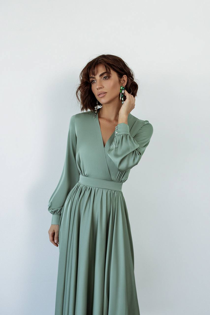 Woman wearing a green dress against a white background