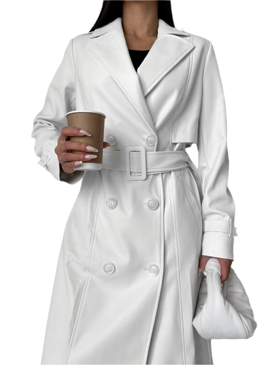 Person wearing a white trench coat holding a coffee cup on a white background