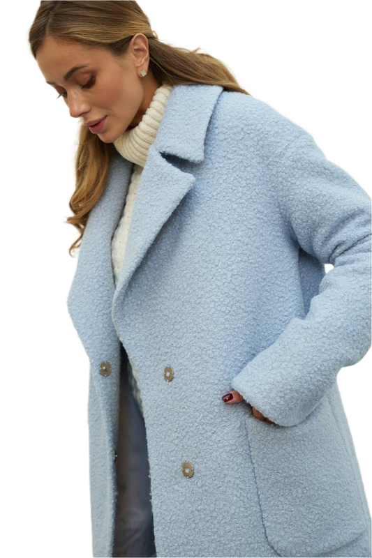 Woman wearing a light blue coat on a white background