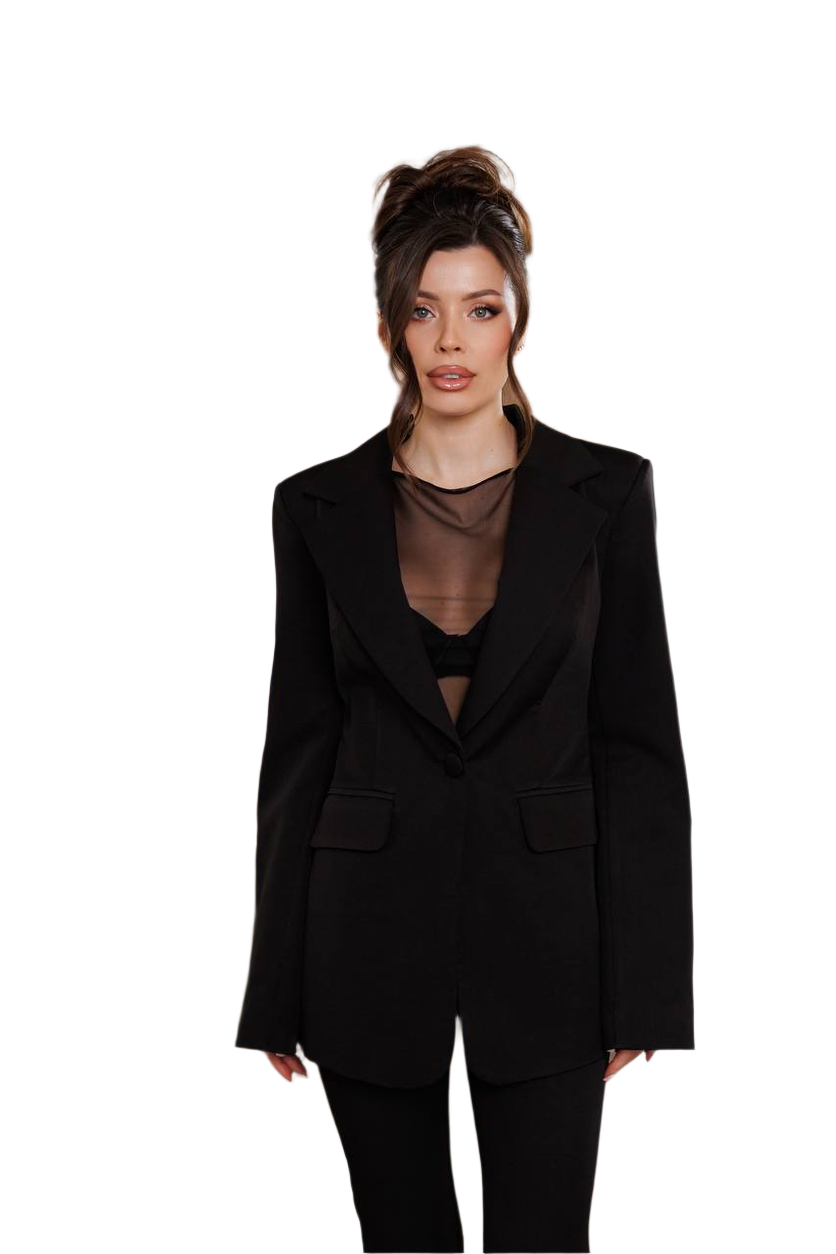 Woman wearing a black suit with sheer top on a white background