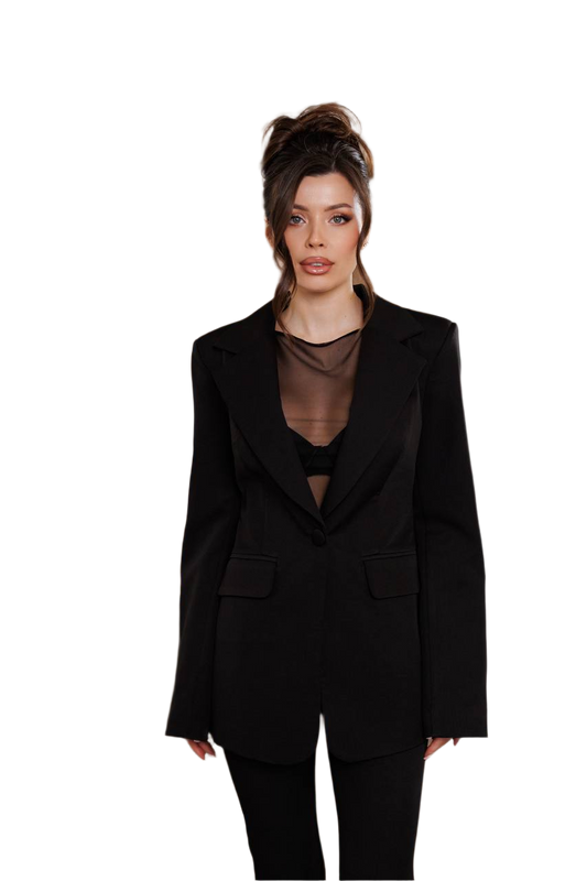 Woman wearing a black suit with sheer top on a white background
