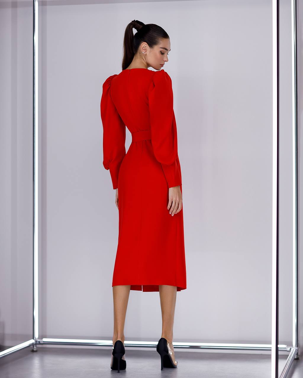Woman wearing a red dress with a plain background