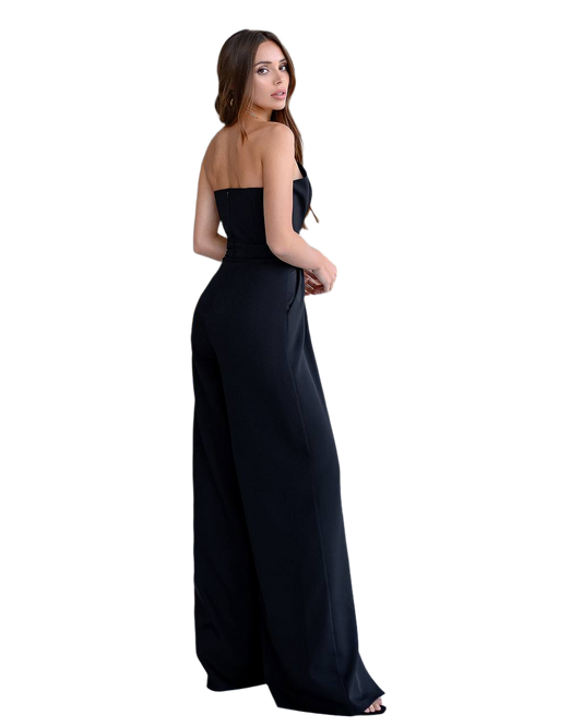 Woman wearing a black strapless gown on a white background