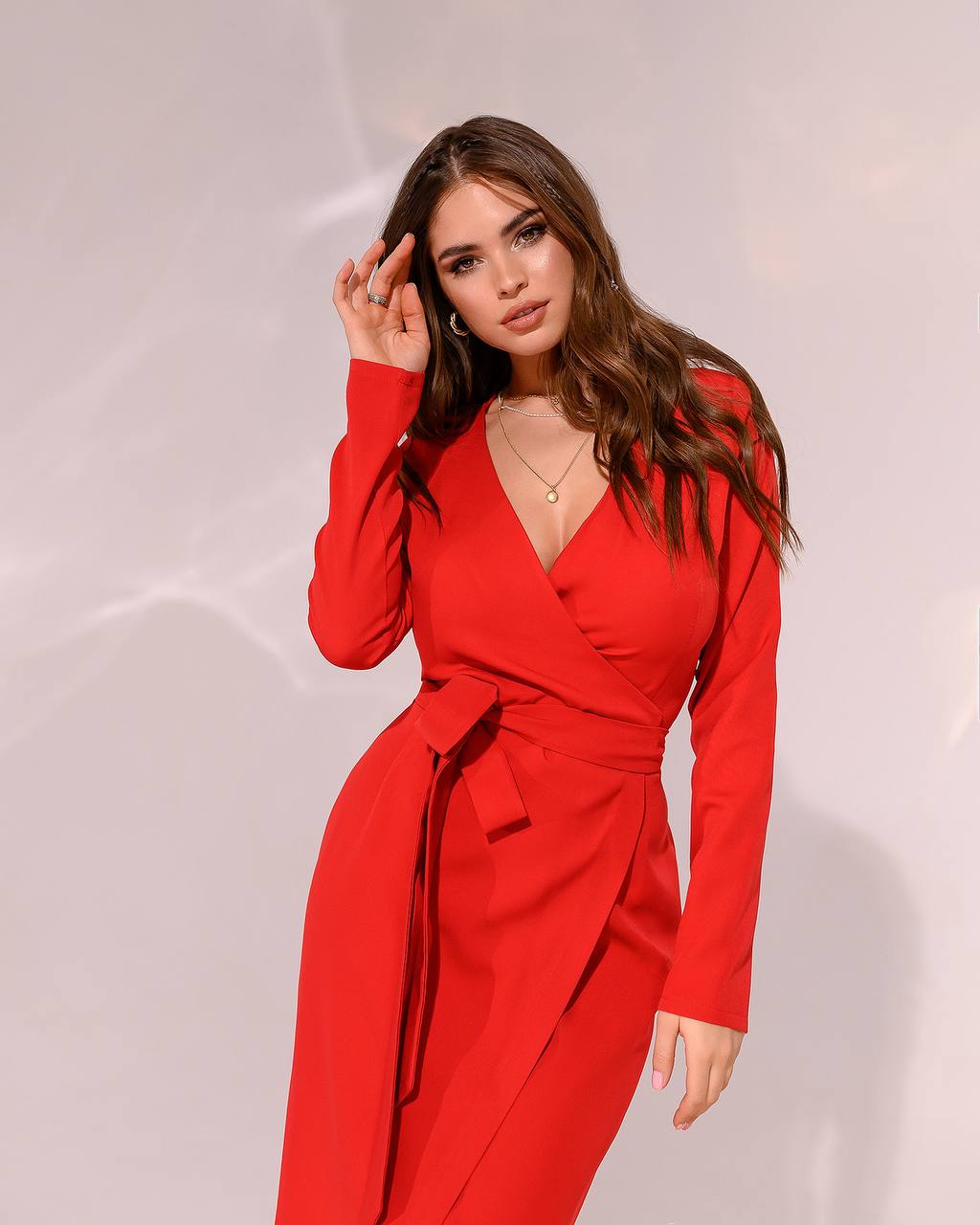 Woman wearing a red dress against a light background