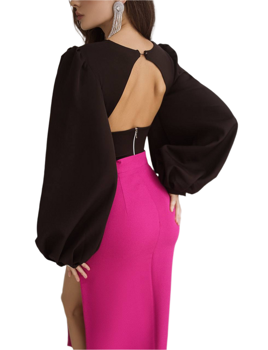 Black top with open back and pink skirt on a white background
