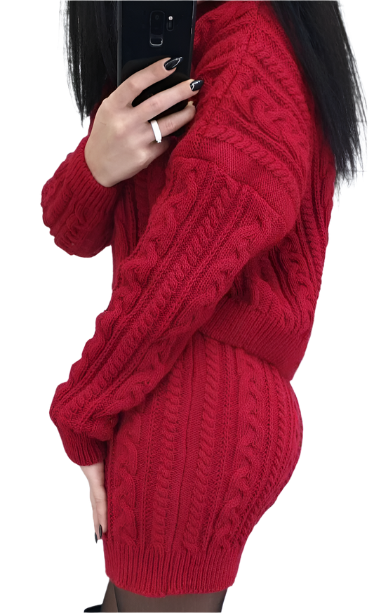Red cable knit sweater worn by a person on a white background