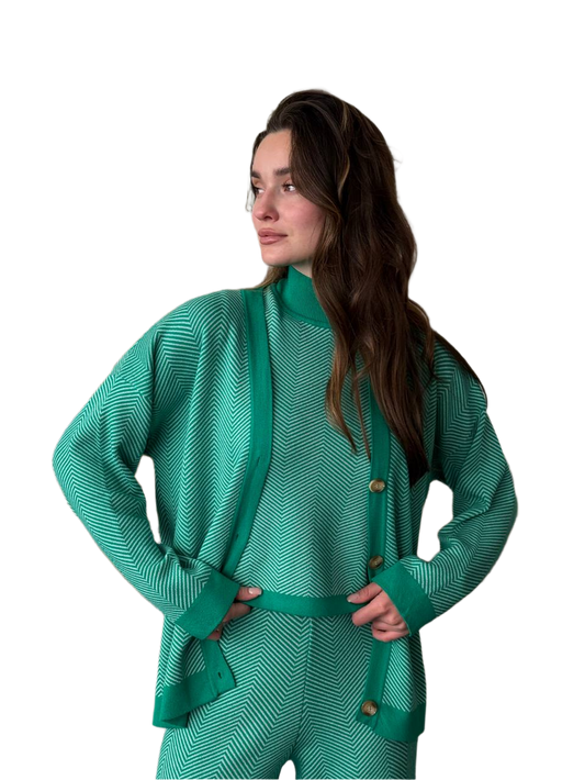 Woman wearing a teal outfit with a matching cardigan on a white background
