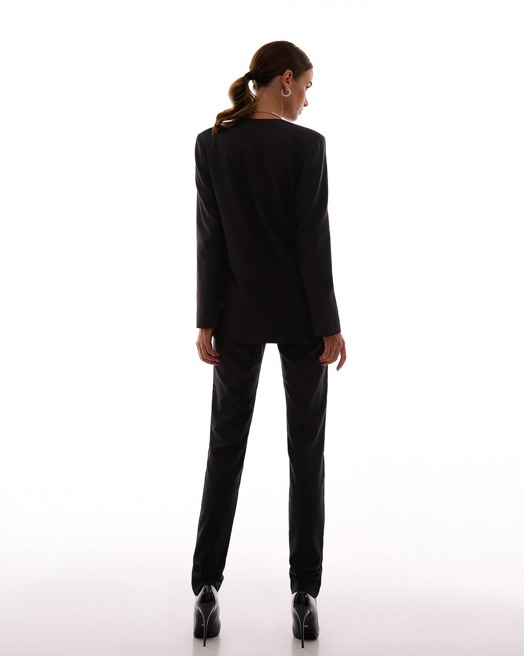 Person wearing a black suit on a white background