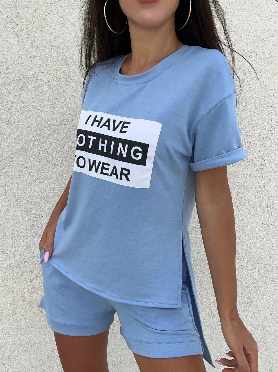 Person wearing a blue t-shirt with a humorous text design against a neutral background