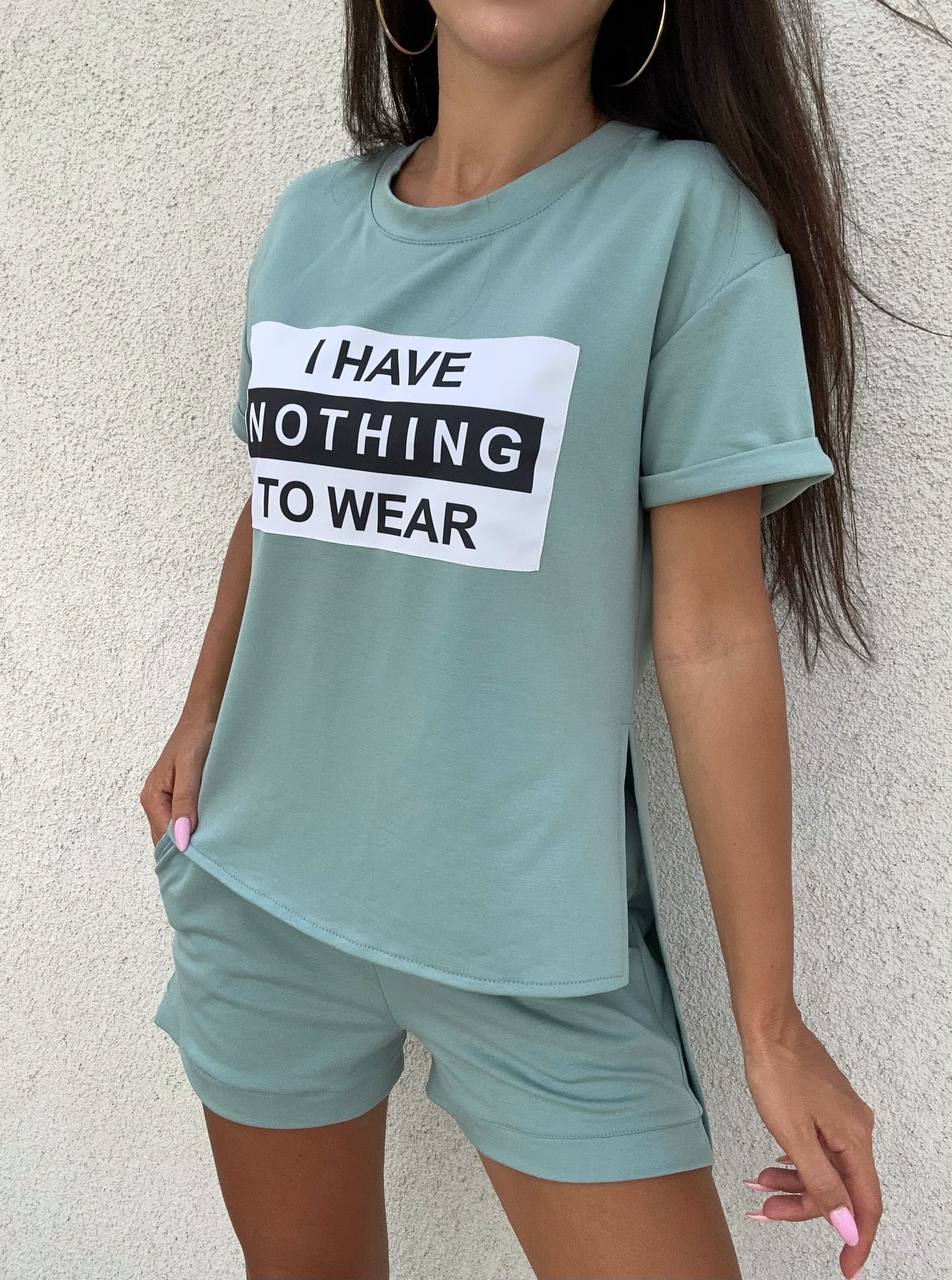 Person wearing a light blue t-shirt with a humorous text design against a neutral background