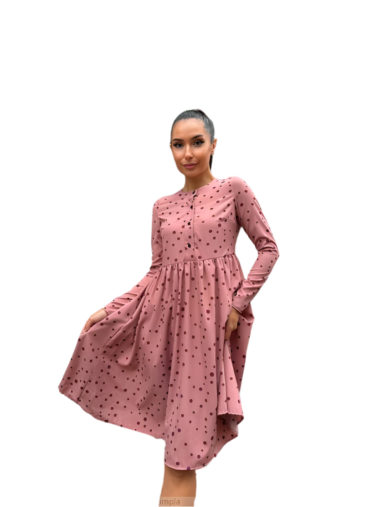 Woman wearing a pink dress with a white background