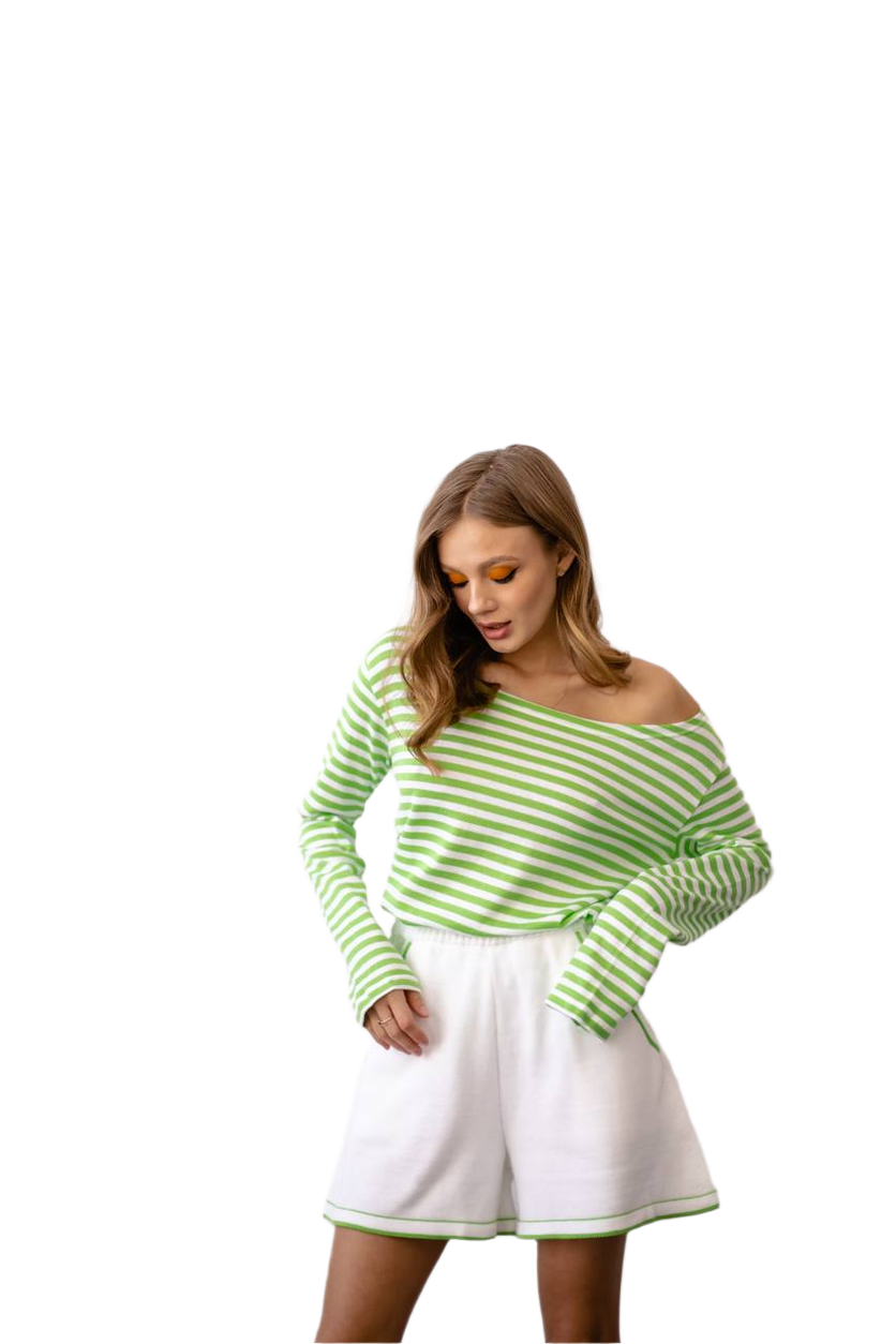 Woman wearing a green and white striped sweater and white skirt on a white background