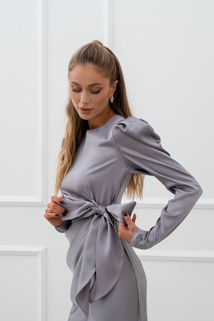 Woman wearing a gray dress with a white background
