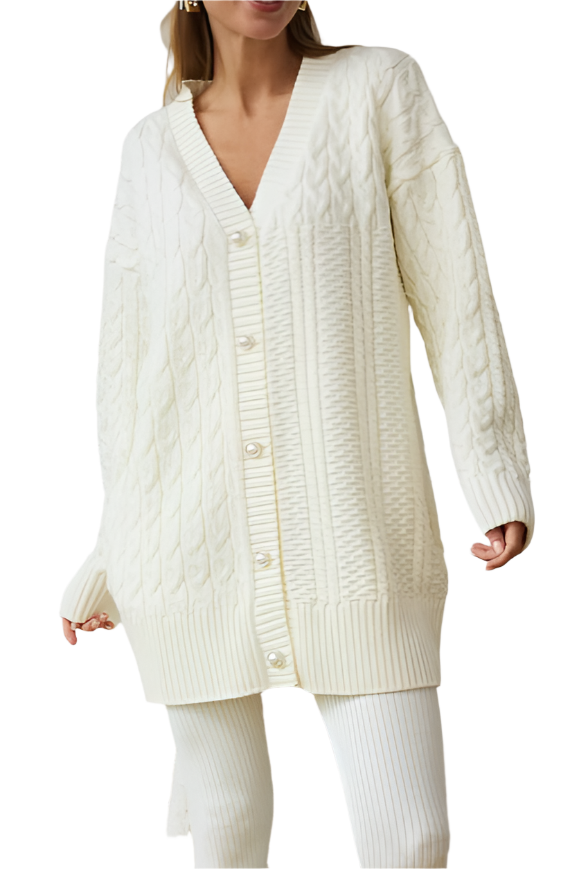 Woman wearing a long cream cable knit cardigan on a white background