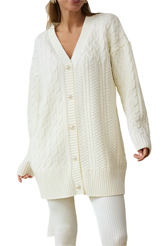 Woman wearing a long cream cable knit cardigan on a white background