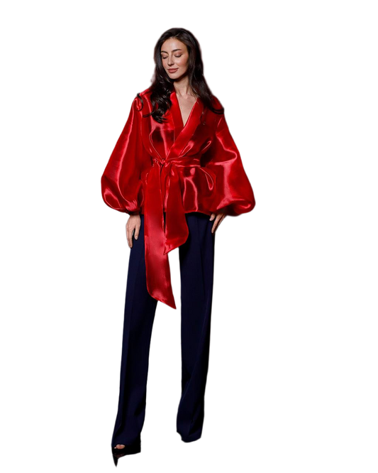 Woman wearing a red satin robe over a black outfit on a white background