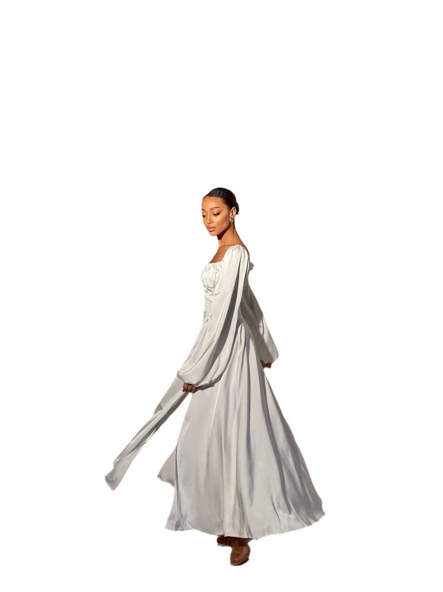 Woman wearing a long, light-colored dress with a flowing train on a white background