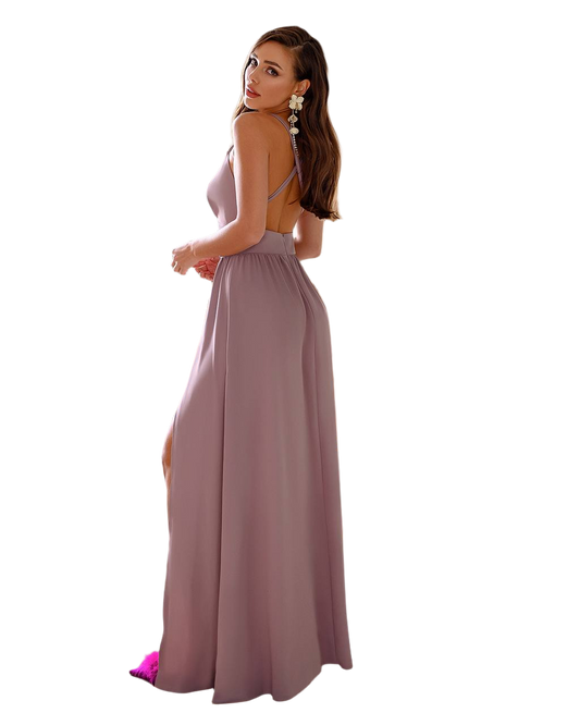 Woman wearing a long mauve dress with a white background