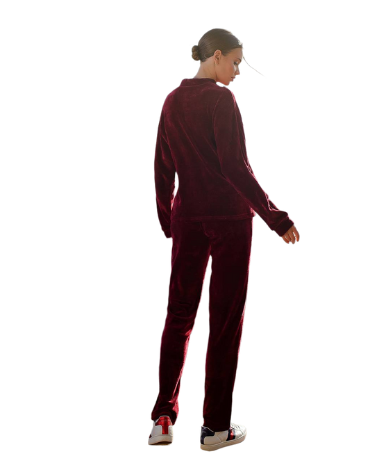 Person wearing a burgundy tracksuit on a white background