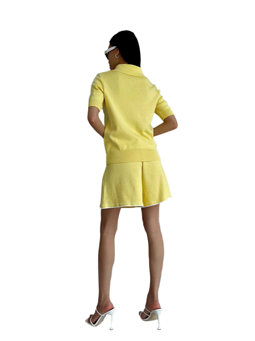 Person wearing a yellow outfit on a white background