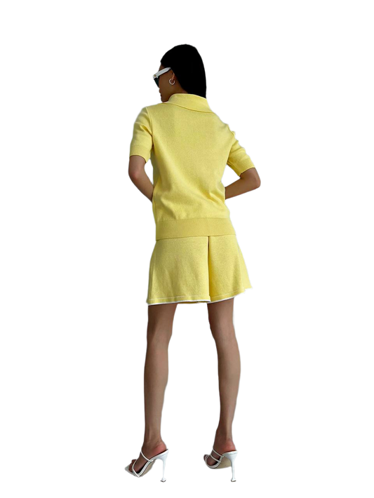 Person wearing a yellow outfit on a white background