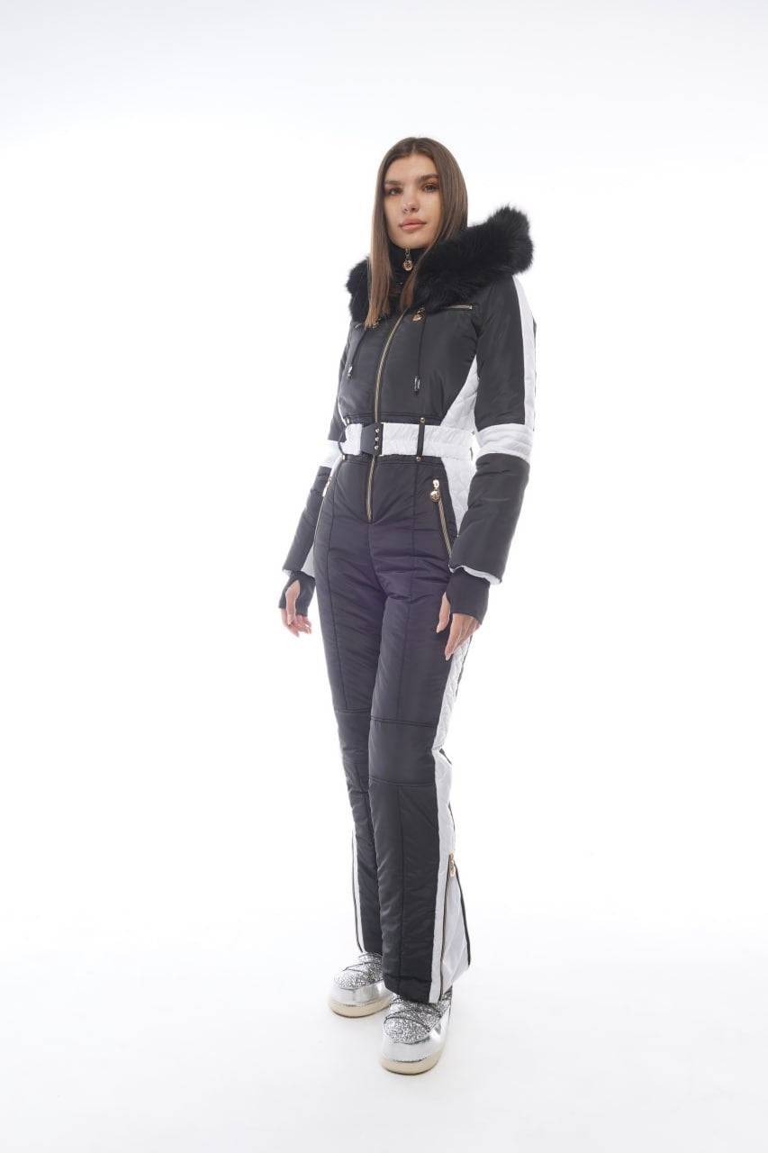 Person wearing a gray ski suit with black fur hood on a white background