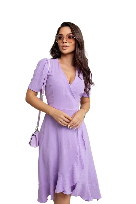 Woman wearing a purple dress with a white background