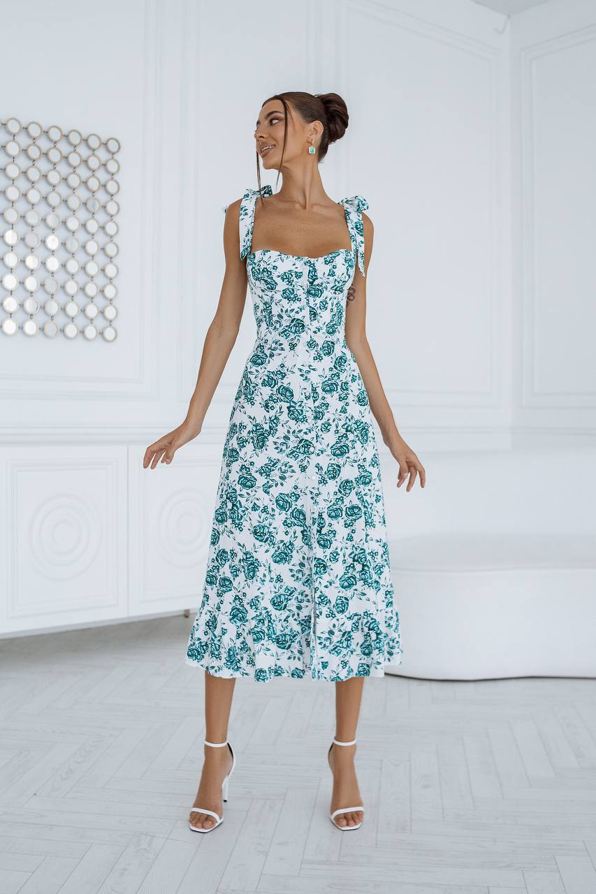 Woman wearing a floral dress in a minimalistic setting