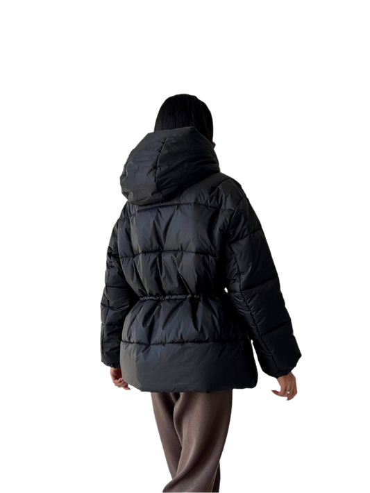Person wearing a black puffer jacket on a white background