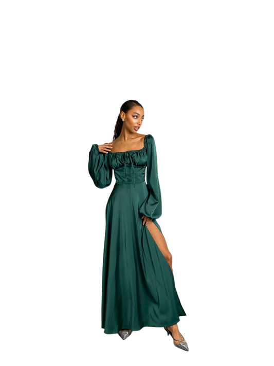 Woman wearing a green dress with long sleeves on a white background