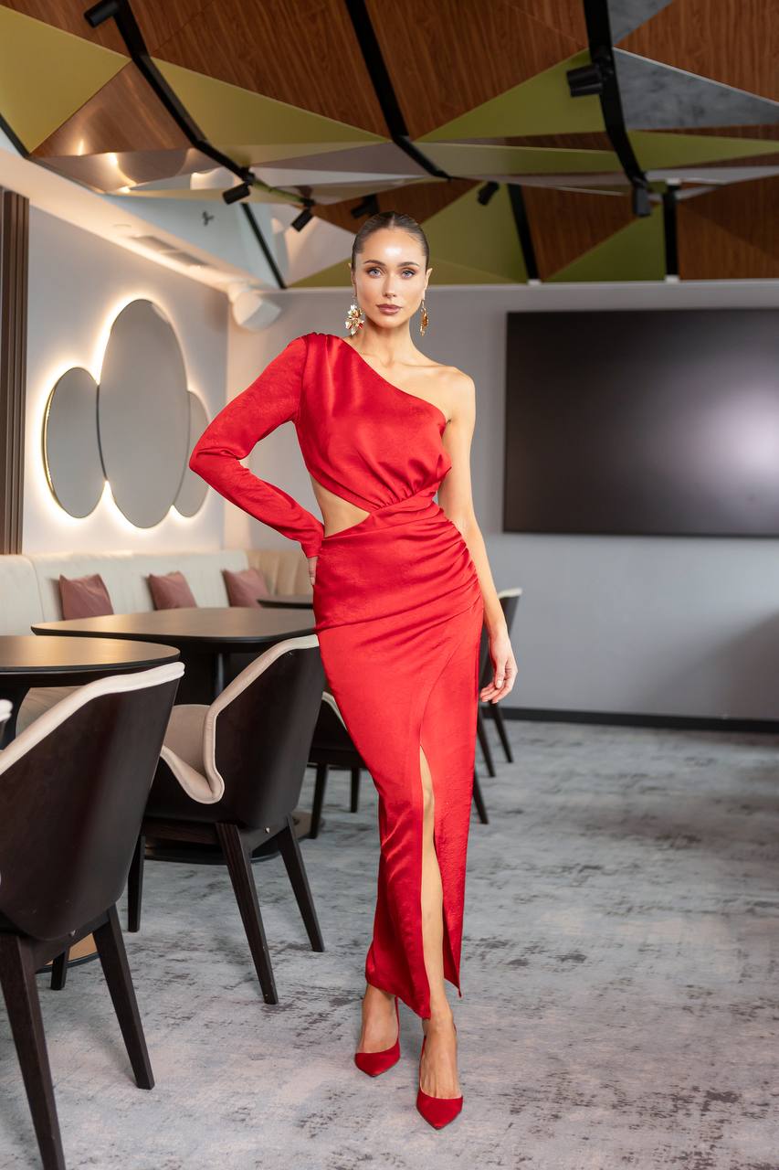 Woman in a red dress standing in a modern restaurant setting