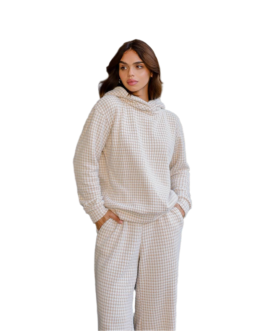 Woman wearing a checkered hoodie and pants on a white background