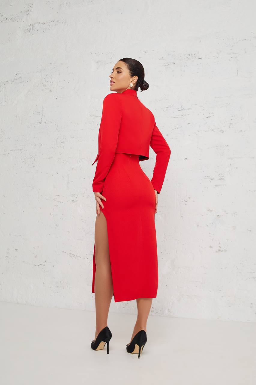Woman wearing a red outfit with a high slit on a white background