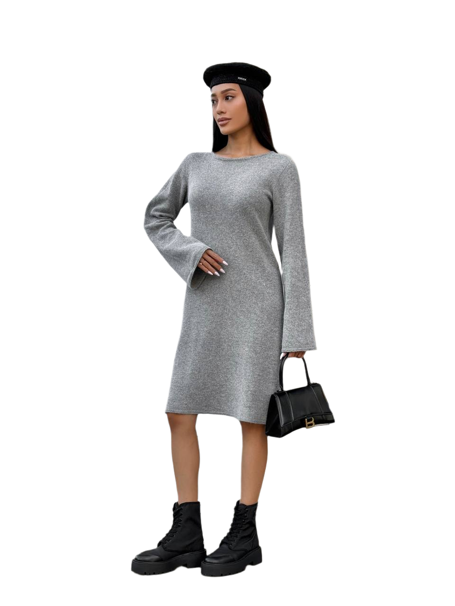 Woman wearing a gray dress with long sleeves, black beret, and black boots on a white background