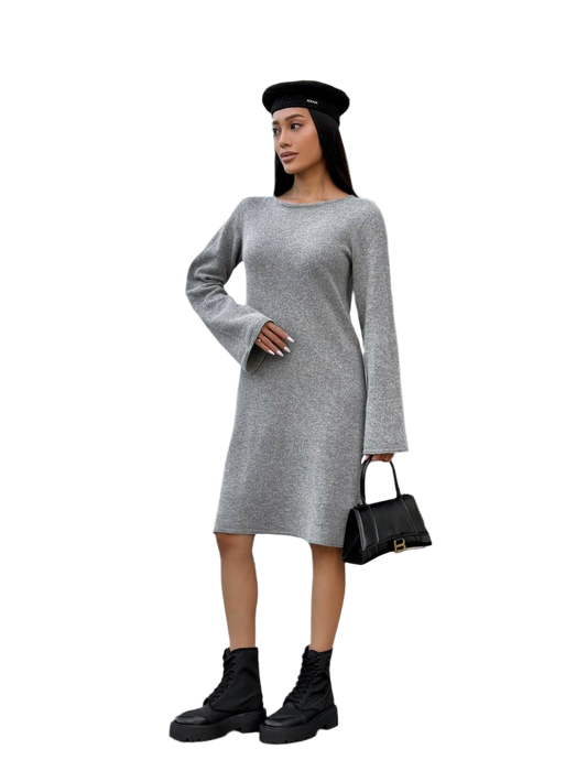 Woman wearing a gray dress with long sleeves, black beret, and black boots on a white background
