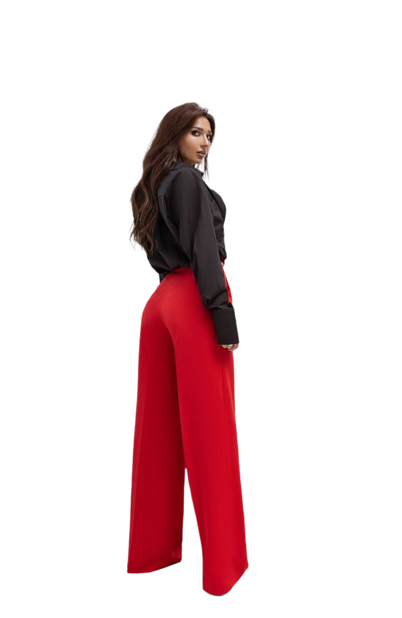 Woman wearing a black top and red pants on a white background